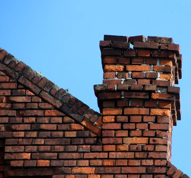 Signs Your Bedford Home Needs a Chimney Inspection Damaged chimney on an Bedford home showing cracks and missing mortar